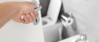 person opening door to a bathroom